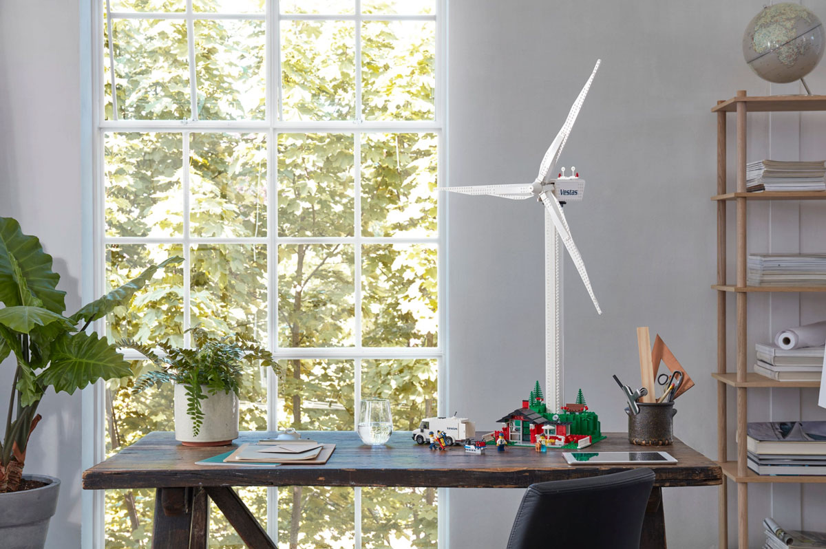 A wind turbine made of LEGO sitting on a desk.