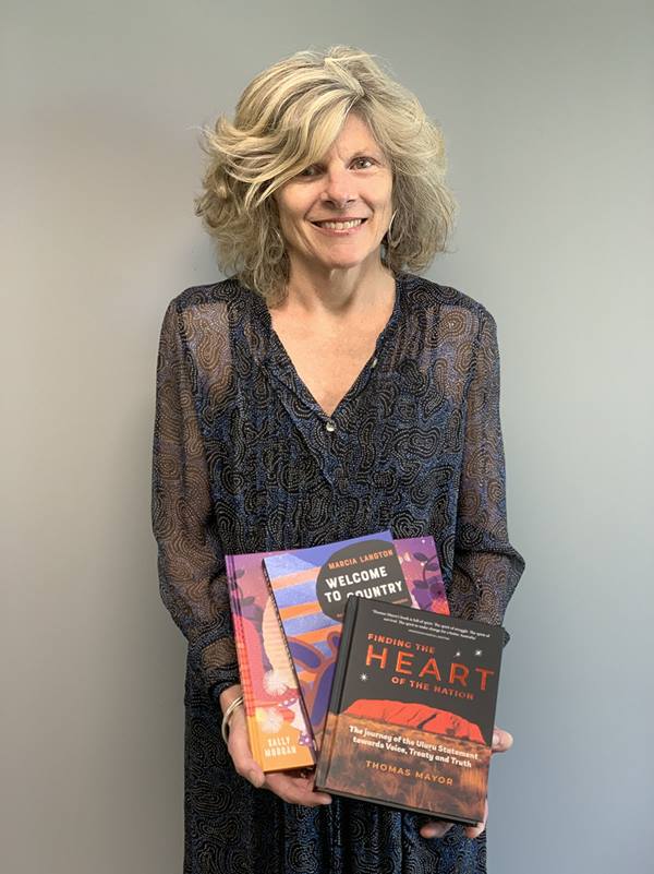 Fiona Hardie holding some of Hardie Grant's Aboriginal and Torres Strait Islander authored books