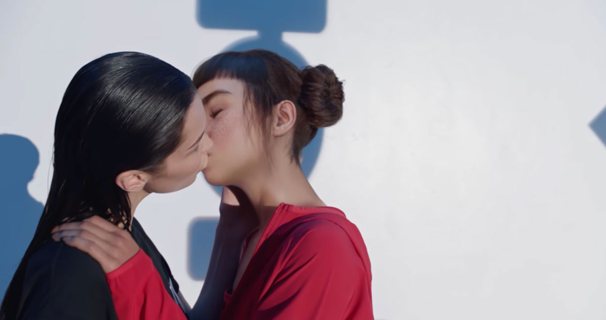 A Calvin Klein ad featuring model Bella Hadid kissing computer-generated influencer Lil Maquela.