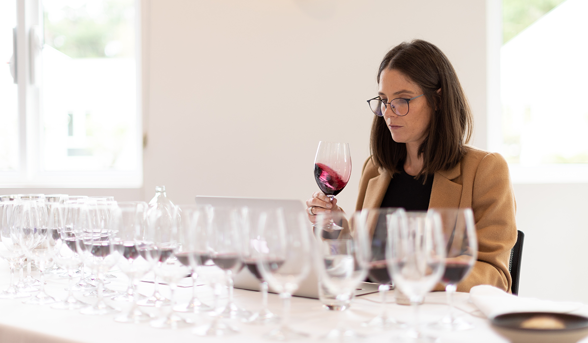 Erin Larkin tasting a selection of wines, and swirling a red wine