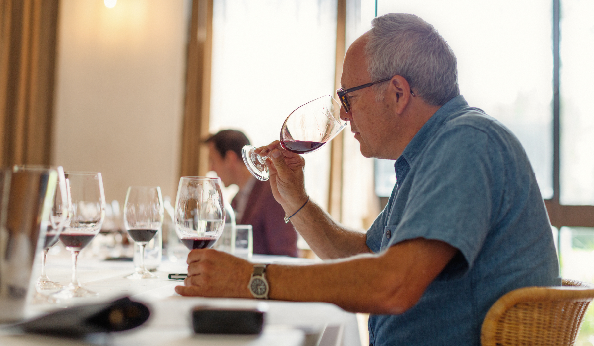 A man tasting wine at a wine judging