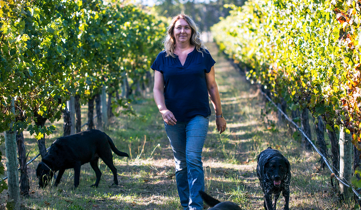 Cath Oates in the vineyard with her dogs