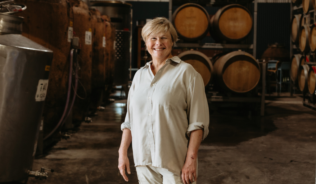 A woman stands in the barrel room at a winery