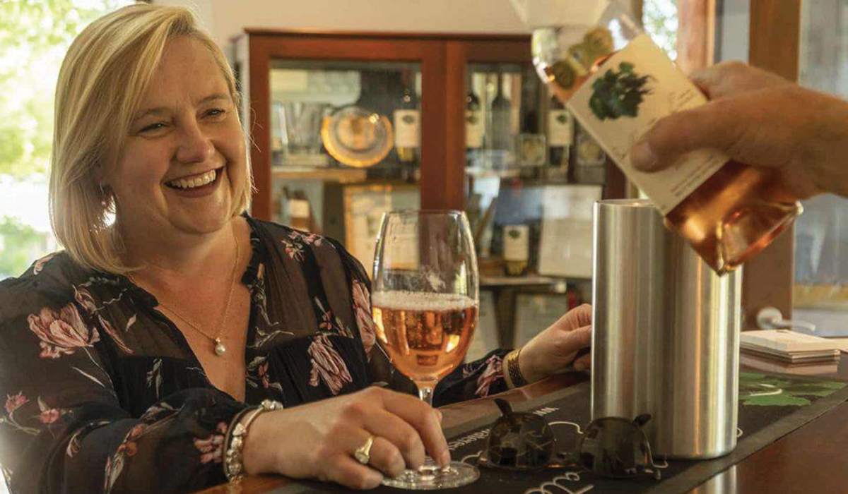 Woman smiling while wine is poured into her glass