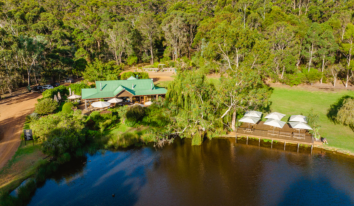 Drone shot of the Lake House Denmark winery with lake in foreground