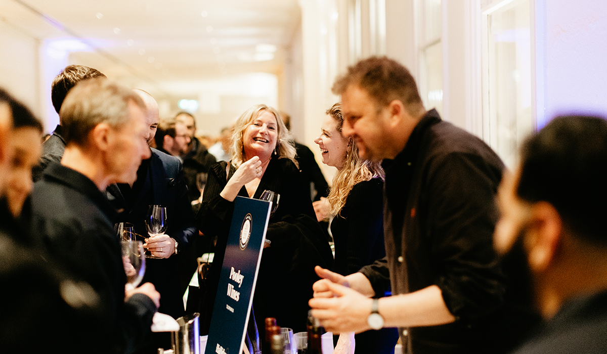 Guests attending a Halliday sip series event and being served by a winemaker from Pooley.