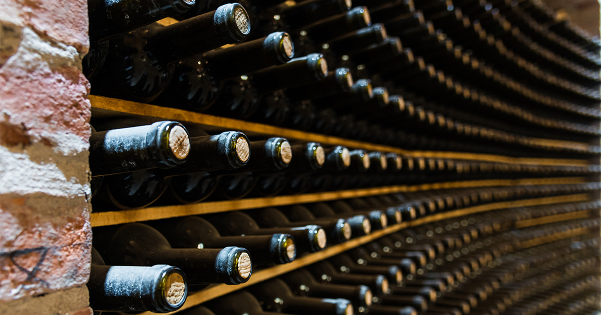 Cork-sealed wine bottles in racks  