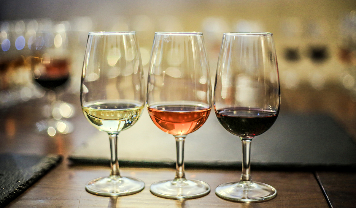 Tasting glasses with white, rosé and red wine