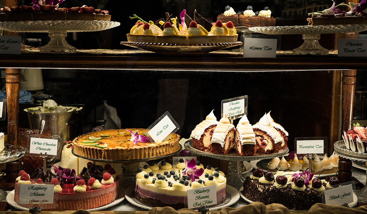 A range of cakes in a window